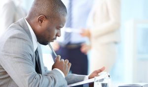 Professional reviewing a document in a bright office