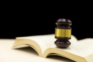 Judge's gavel resting on an open law book